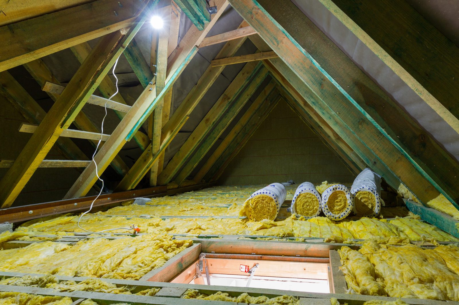 Attic with fiberglass insulation and roof structure