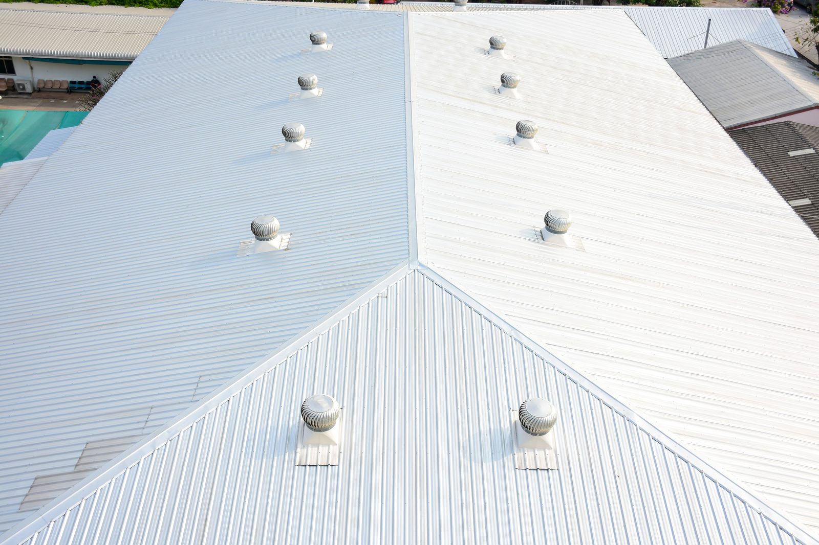 Commercial metal roof with ventilation systems