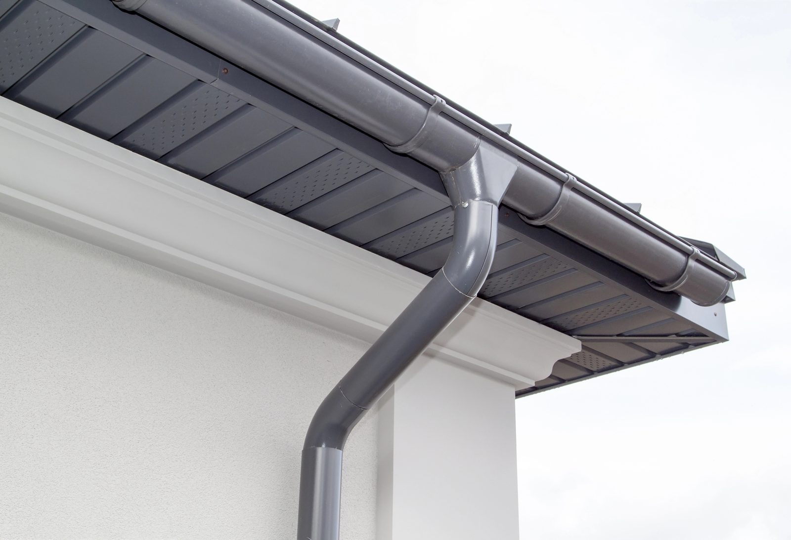 Metal gutter and downspout on residential roof