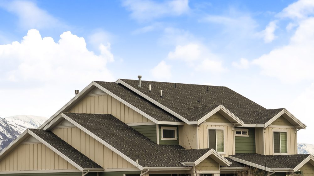 Large home with dark architectural shingles