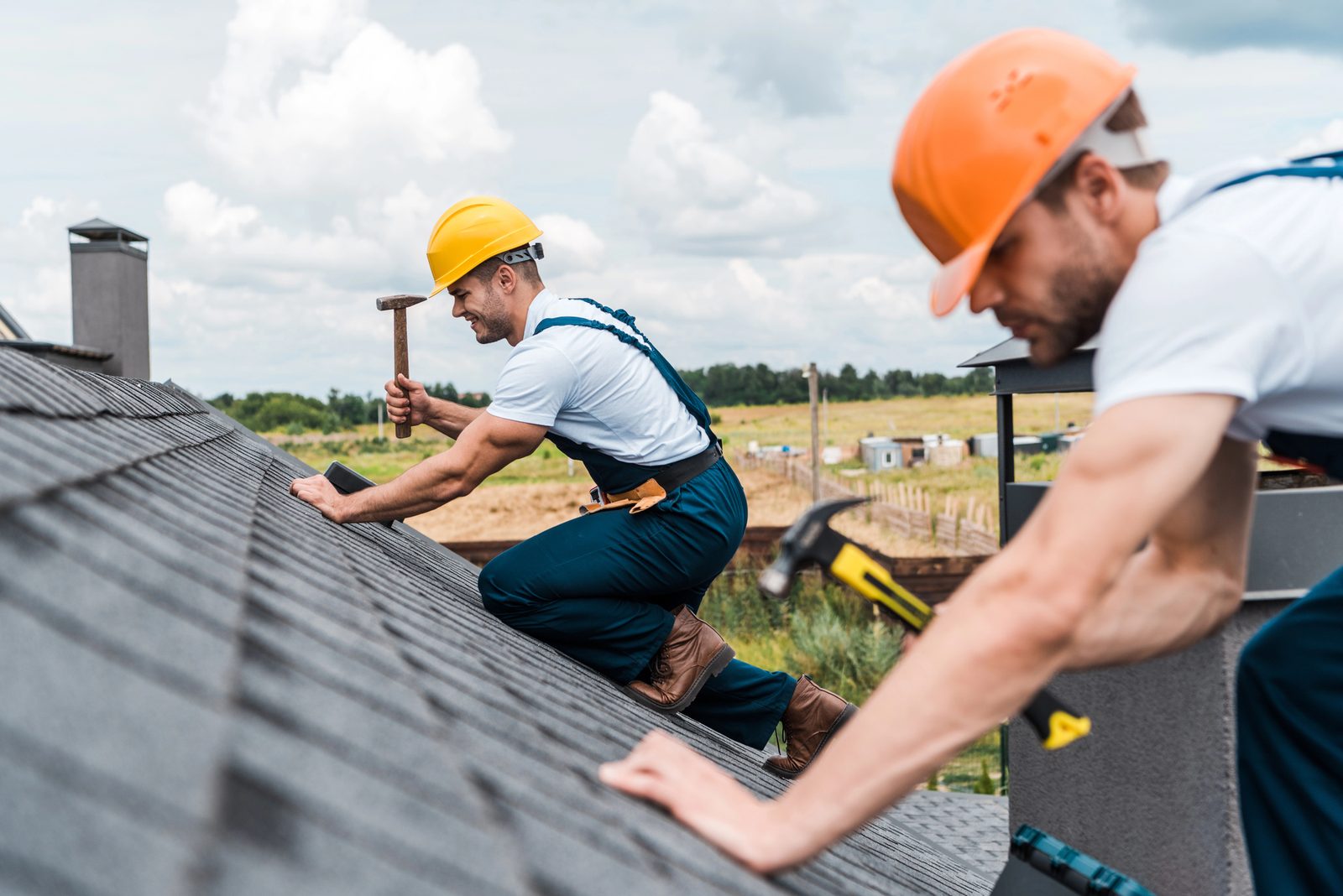 Roofer wearing safety harness during installation
